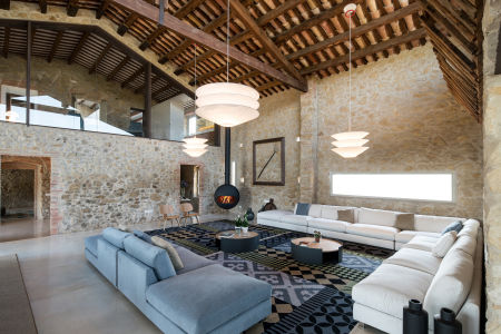 Bubble Wood fireplace by Antrax warms the living area of a stylish farmhouse in Girona, Spain